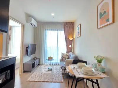 Modern living room with cozy decor and natural light, featuring a stylish sofa and dining area.