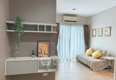 Cozy living room with natural light, modern decor, and comfortable seating.