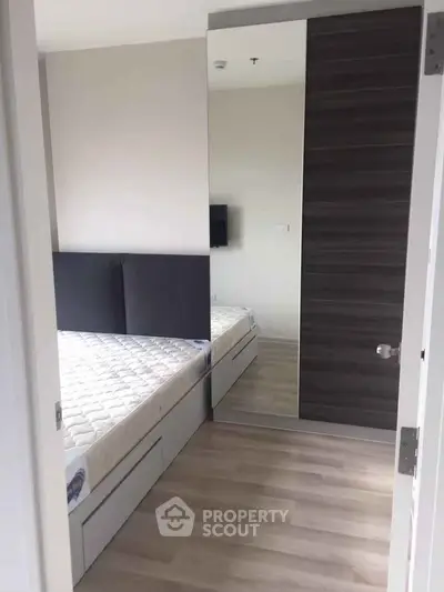 Modern bedroom with mirrored wardrobe and sleek flooring