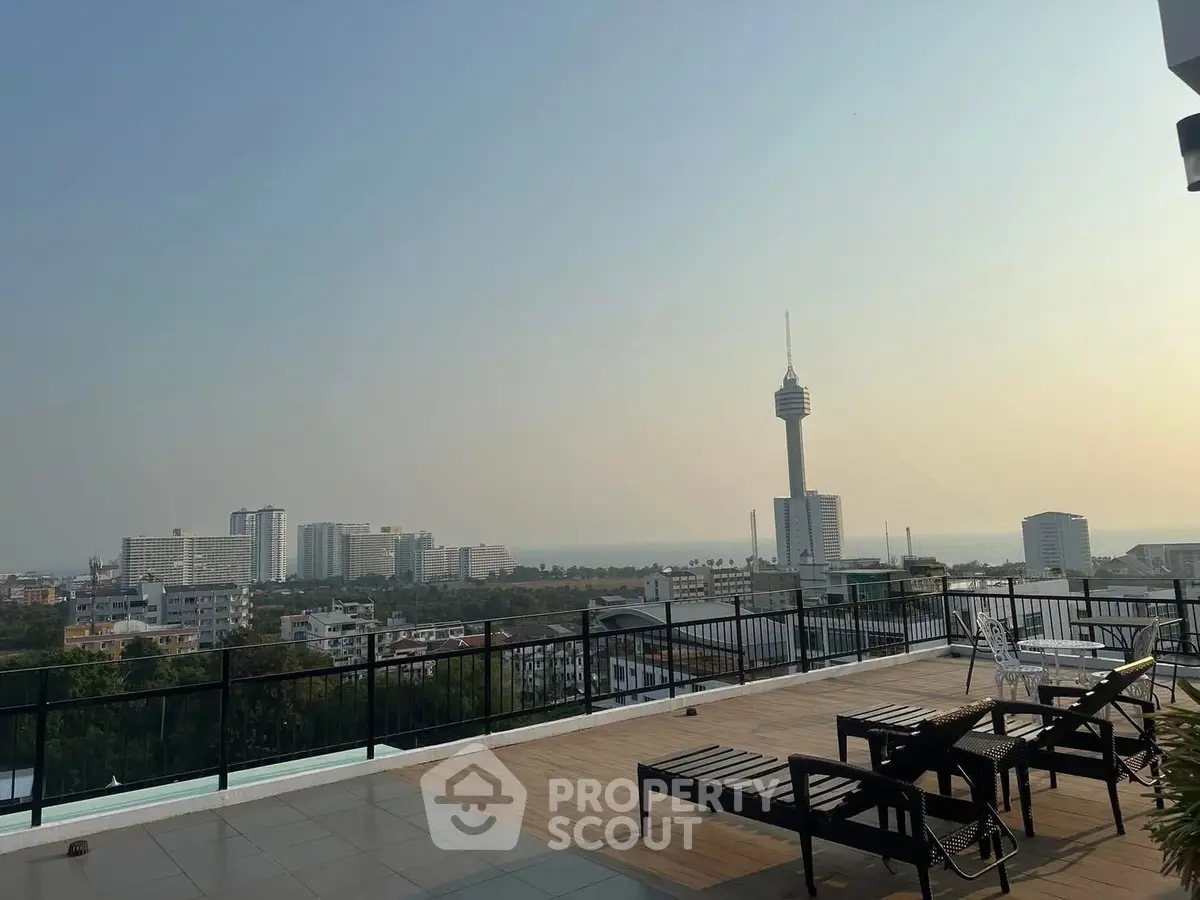 Stunning rooftop view with cityscape and iconic tower, perfect for relaxation and urban living.