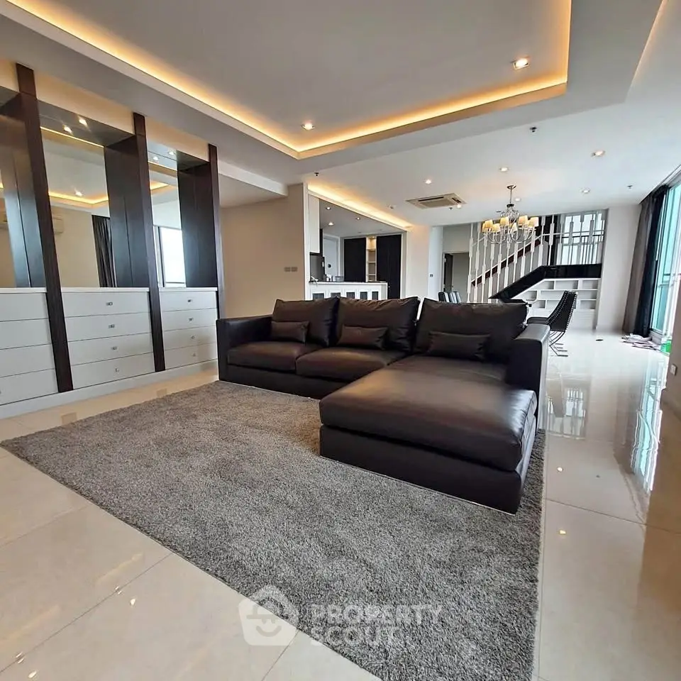 Luxurious modern living room with sleek design and spacious layout, featuring elegant lighting and stylish furniture.