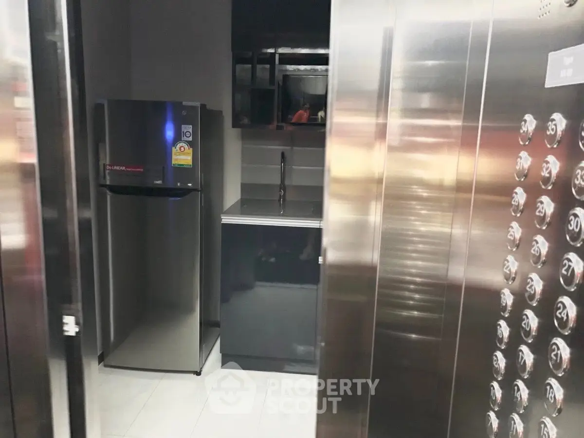 Modern elevator interior with sleek design and reflective surfaces