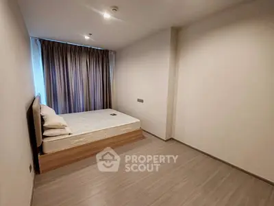 Minimalist bedroom with bed and curtains in modern apartment