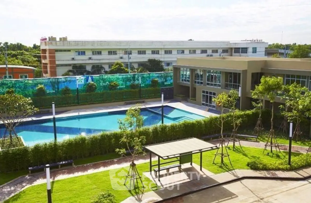 Modern residential complex with pool and landscaped garden