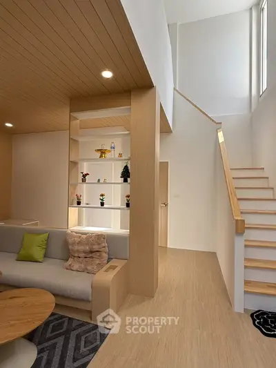 Modern living room with wooden accents and stylish staircase