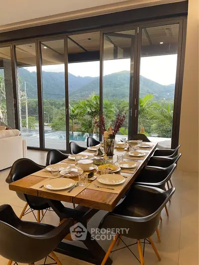 Luxurious dining area with stunning mountain view, featuring elegant table setting and modern design.
