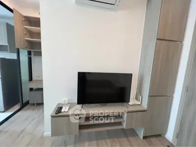 Modern living room with sleek TV unit and stylish wooden cabinetry
