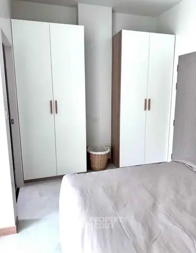 Spacious bedroom with modern wardrobes and cozy bed setup