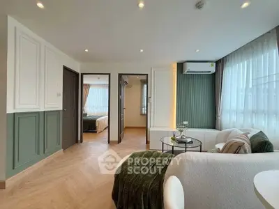 Modern living room with elegant decor and natural light, featuring cozy seating and stylish accents.