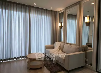 Elegant living room with cozy sofa and floor-to-ceiling curtains