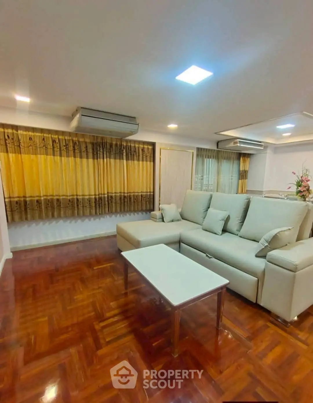 Spacious living room with elegant parquet flooring and modern furniture