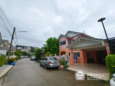 Charming suburban house with carport and lush greenery in a peaceful neighborhood.