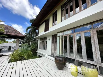 Stunning tropical villa exterior with lush garden and spacious deck