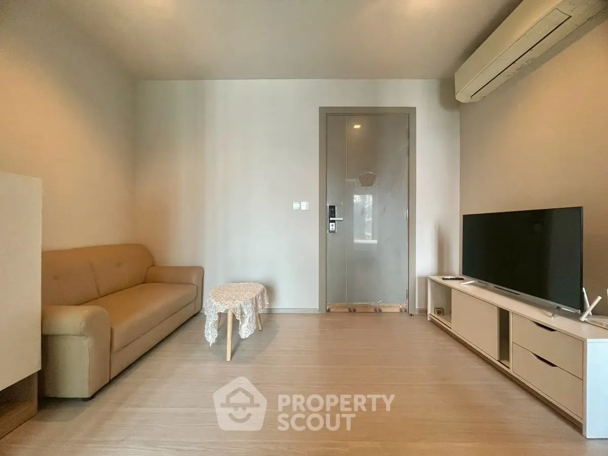 Modern living room with sleek furniture and air conditioning in a cozy apartment.