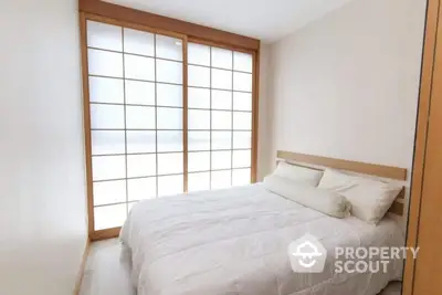 Minimalist bedroom with shoji screen and cozy bedding