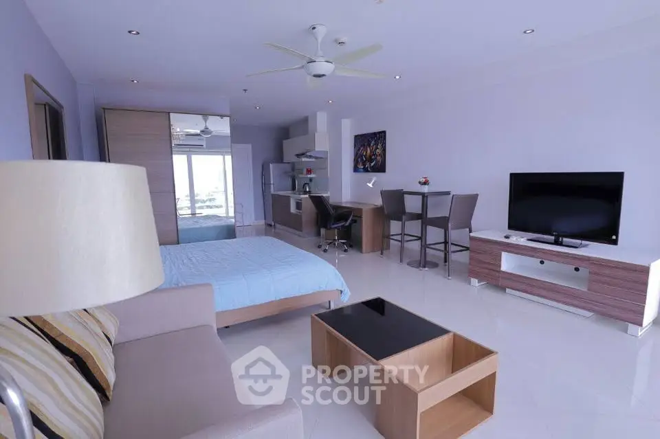 Modern open-plan studio apartment with sleek furnishings and natural light.