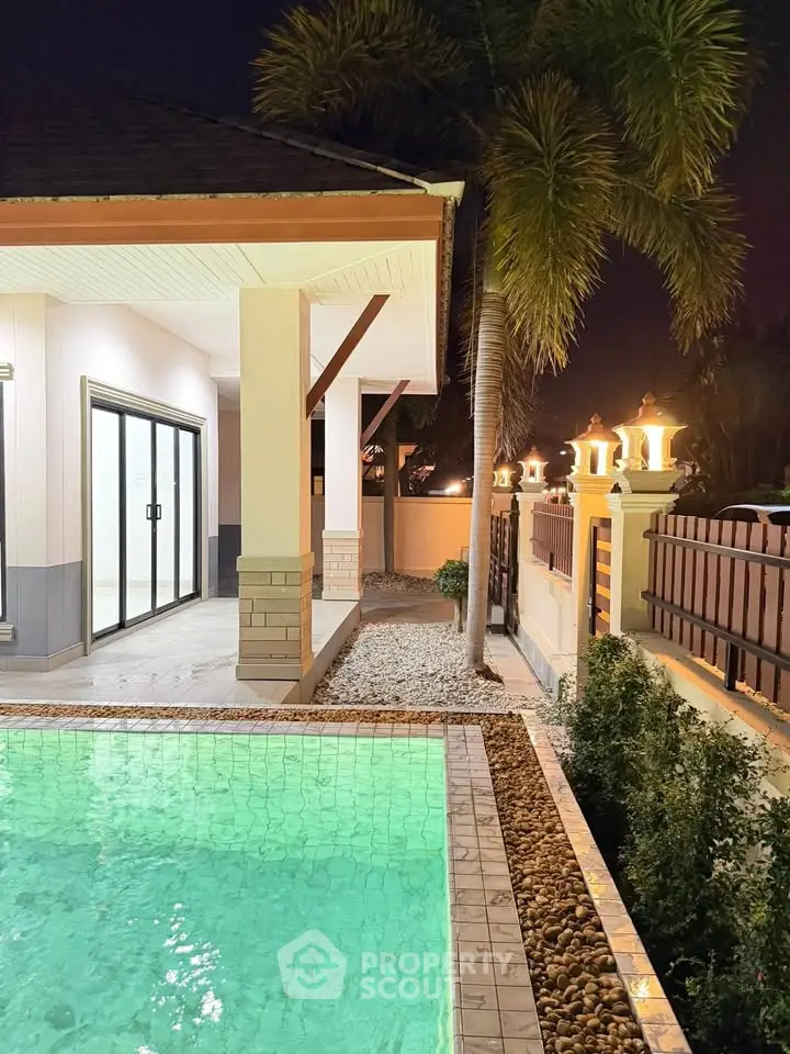 Luxurious villa with private pool and elegant exterior lighting at night