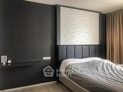 Modern bedroom with stylish headboard and elegant decor, perfect for a cozy retreat.