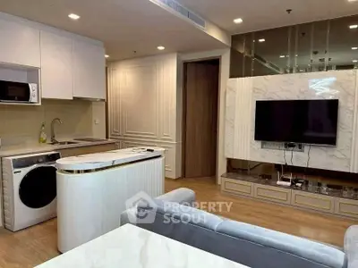 Modern open-layout living room with sleek kitchen and stylish TV wall unit.