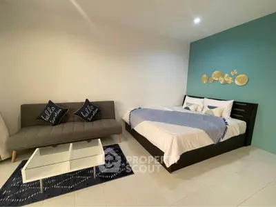 Modern bedroom with stylish decor and cozy seating area