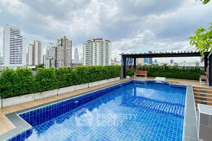 Luxurious rooftop pool with stunning city skyline views and lush greenery.