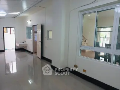 Spacious interior with glossy floors and large windows, ideal for modern living.