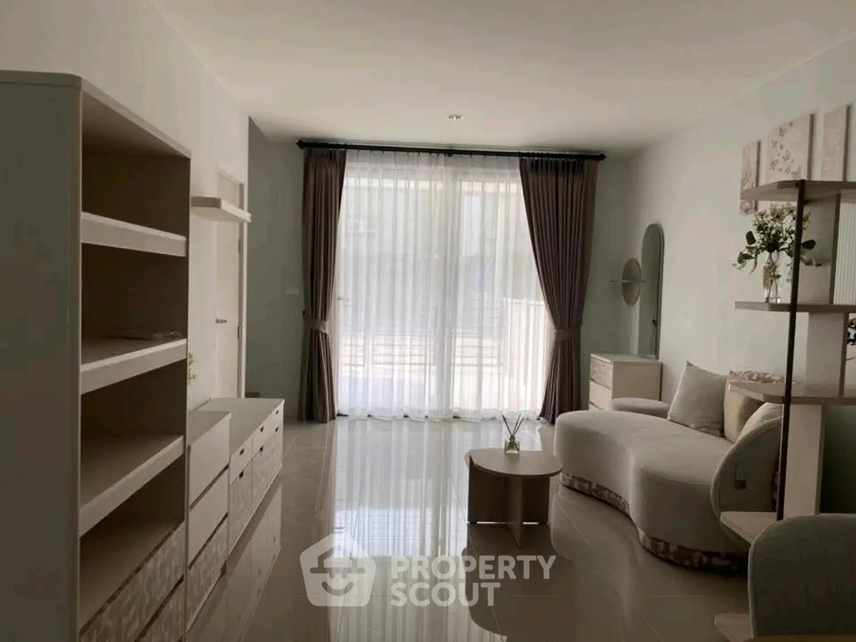 Spacious living room with modern furniture and large window