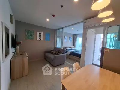 Modern open-plan living room with stylish decor and cozy bedroom view