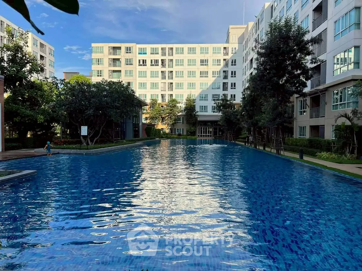 Luxurious apartment complex with a stunning outdoor pool and lush greenery, perfect for relaxation and leisure.