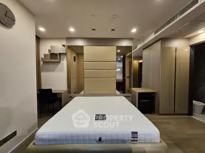 Luxurious modern bedroom with elegant design and ample storage space, featuring a comfortable bed and stylish decor.