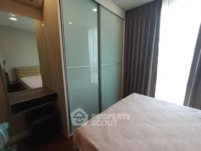 Cozy bedroom with modern sliding wardrobe and ample natural light