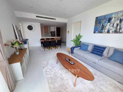 Spacious modern living room with stylish decor and open kitchen layout.