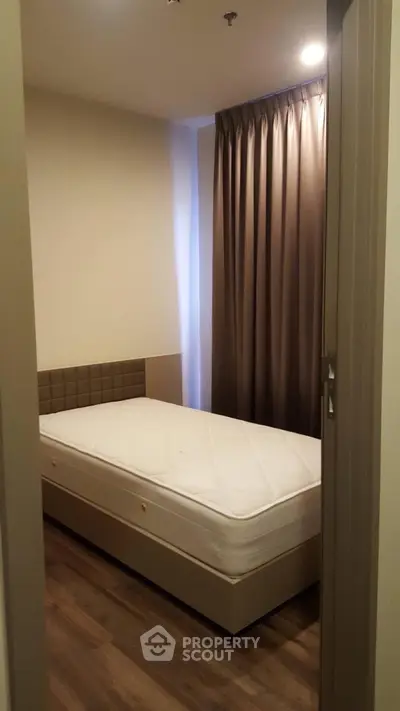 Cozy small bedroom with single bed and elegant curtains