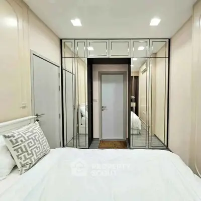 Modern bedroom with mirrored closet doors and stylish decor