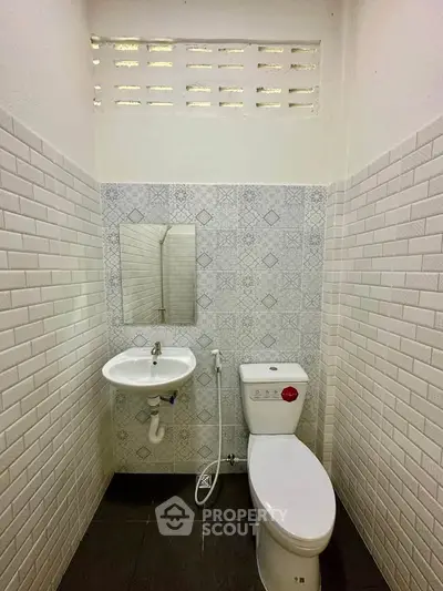 Compact bathroom with modern fixtures and stylish tile design