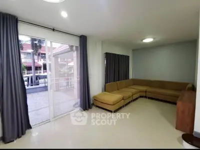 Spacious living room with modern sectional sofa and large sliding glass doors