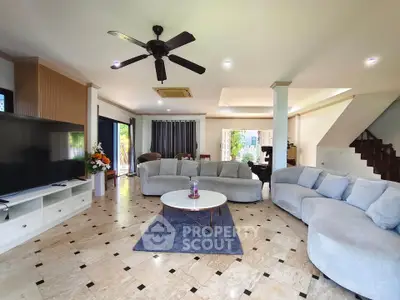 Spacious living room with modern decor and large windows for natural light.