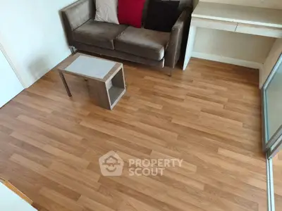 Cozy living room with wooden flooring and modern furniture, perfect for relaxation.