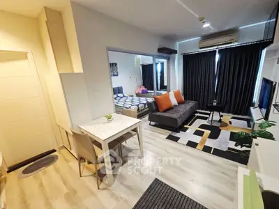 Modern studio apartment with stylish decor and open layout, featuring a cozy living area and bedroom.