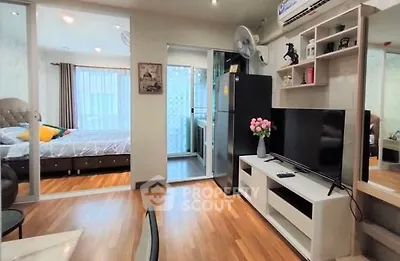 Modern apartment interior with cozy living room and bedroom, featuring wooden flooring and stylish decor.