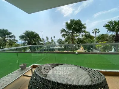 Luxurious balcony with stunning garden view and modern outdoor furniture.