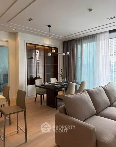 Modern living room with elegant dining area and large windows in a luxury apartment.