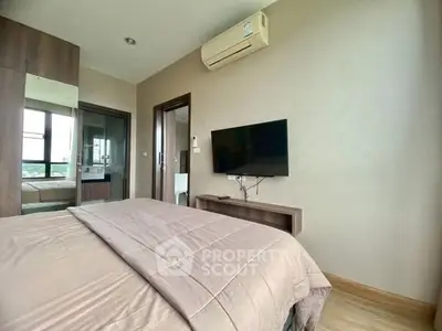 Modern bedroom with wall-mounted TV and air conditioning unit