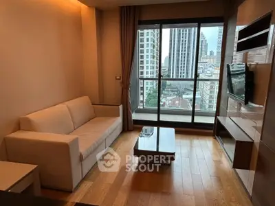 Modern living room with city view, featuring sleek furniture and large windows in urban apartment.
