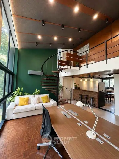 Stunning modern loft with spiral staircase and open kitchen layout, featuring large windows and stylish decor.
