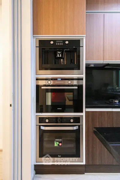 Modern kitchen with built-in appliances and sleek cabinetry