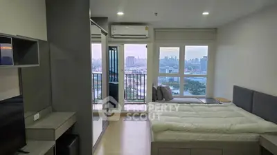 Modern bedroom with city view and balcony access in high-rise apartment