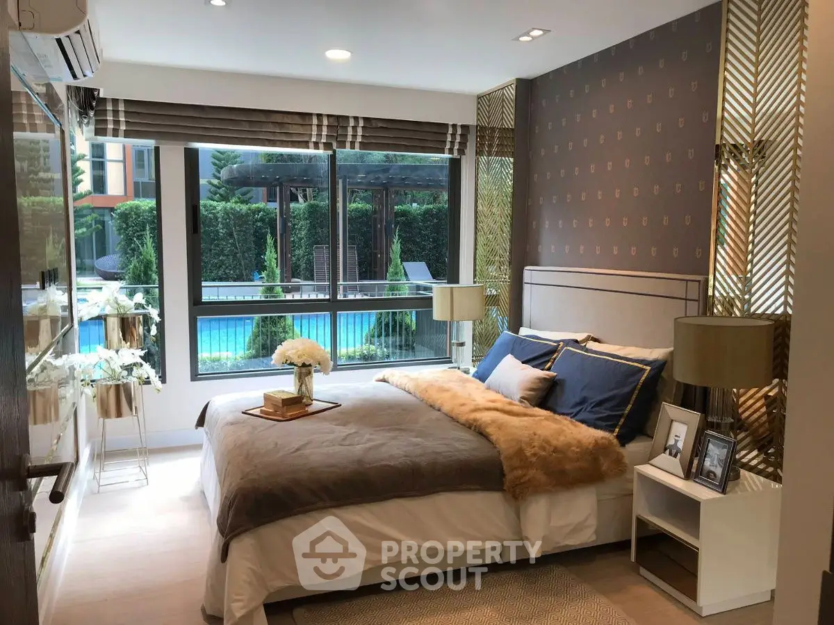 Luxurious bedroom with pool view, elegant decor, and modern furnishings.