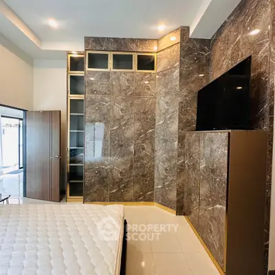 Luxurious bedroom with marble walls and modern built-in wardrobe