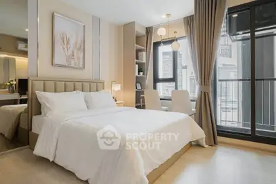 Luxurious bedroom with modern decor and city view, featuring a cozy bed and elegant furnishings.